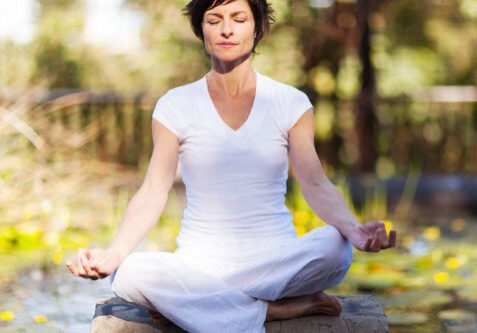 Photo of a woman sitting in meditation