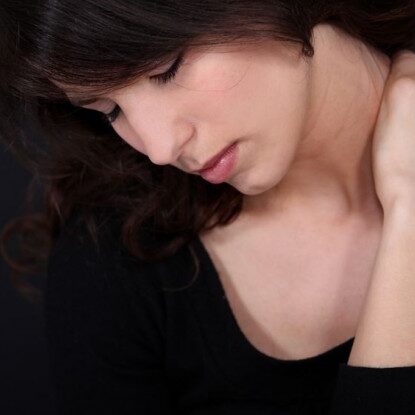 Photo of woman rubbing herr neck