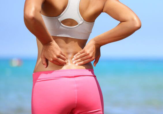 Photo of woman with her hands on her lower back